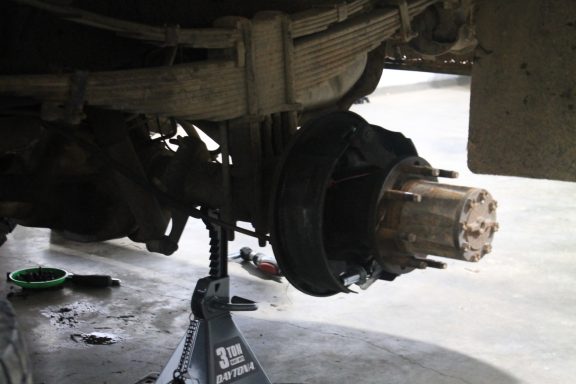 Closeup of a car on jacks with the tire removed